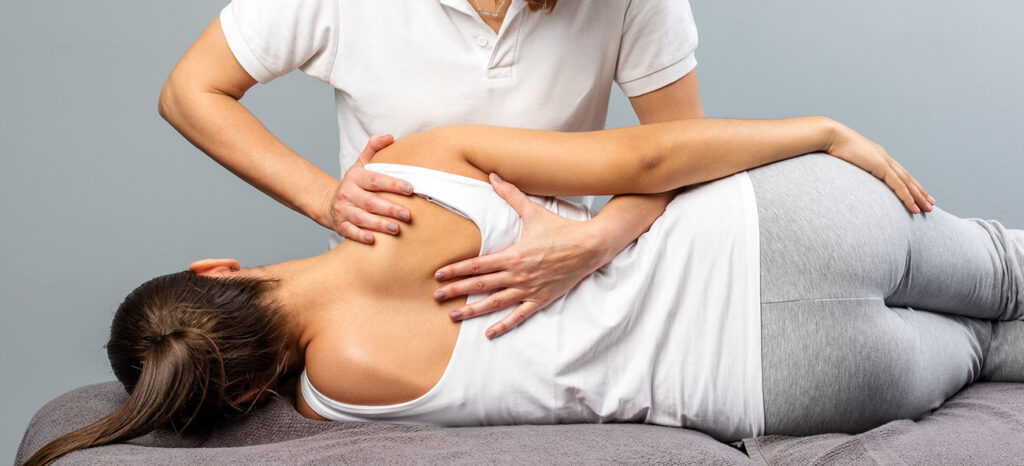 chiropractor adjusting a patient's back in Bend, Oregon.